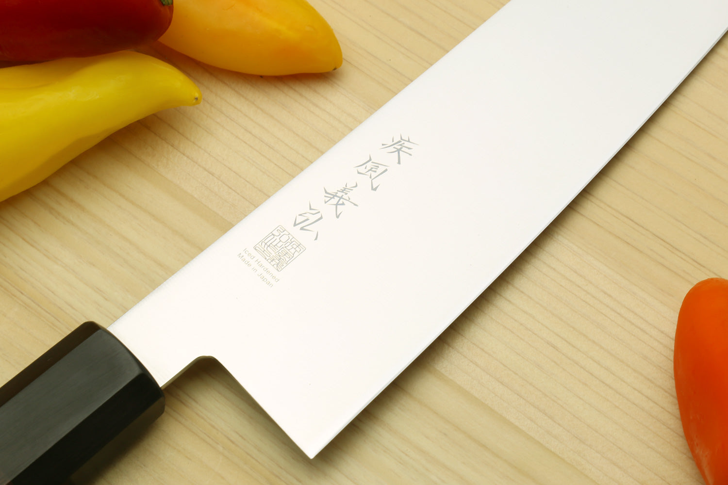 Stainless kiritsuke chef knife tip with etched logo and dark rosewood handle