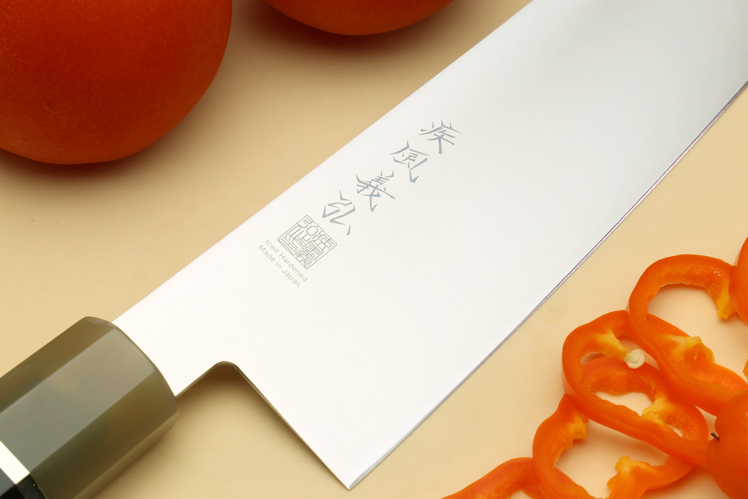 Kiritsuke chef knife blade with engraved markings, dark triple-ring handle