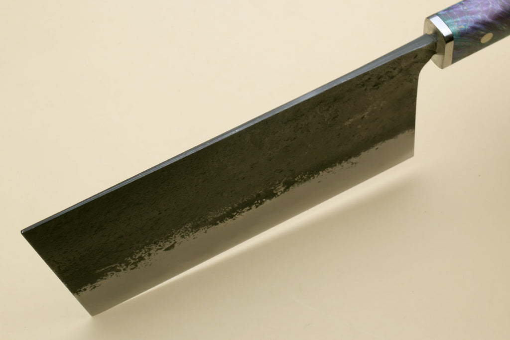Chinese-style cleaver knife, dark mottled blade viewed from side; handle end visible