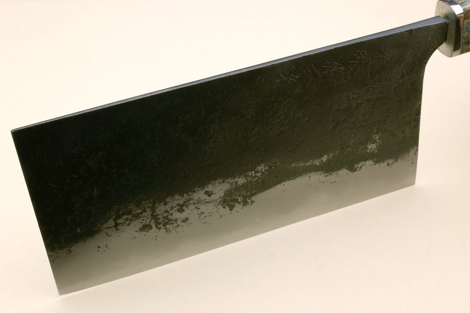 Chinese-style cleaver knife with flat side view of speckled silver blade