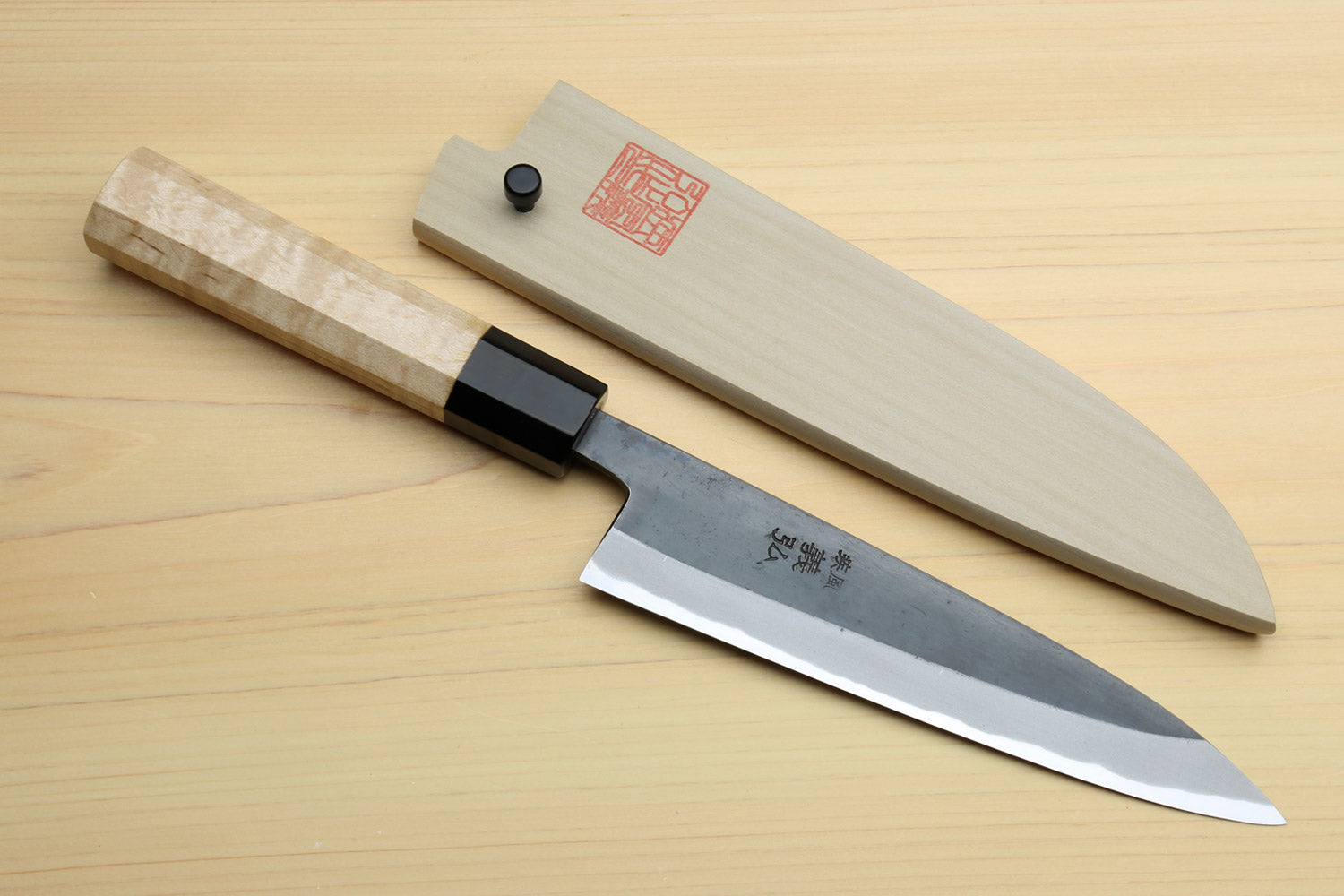 Petty utility knife with light wood handle and matching saya cover, black bolster detail