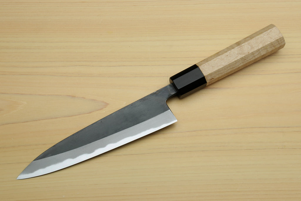 Petty utility knife with dark blade, white-steel edge, and light wood handle with black bolster