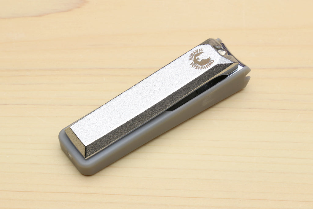 Japanese nail clippers with textured nail file and gray base, brand label on top