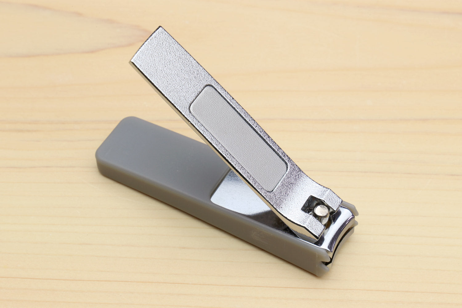 Silver-colored Japanese nail clippers with gray protective case