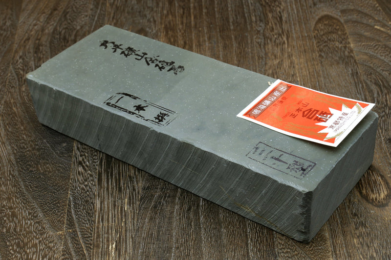 Natural sharpening whetstone block, dark gray with label on top