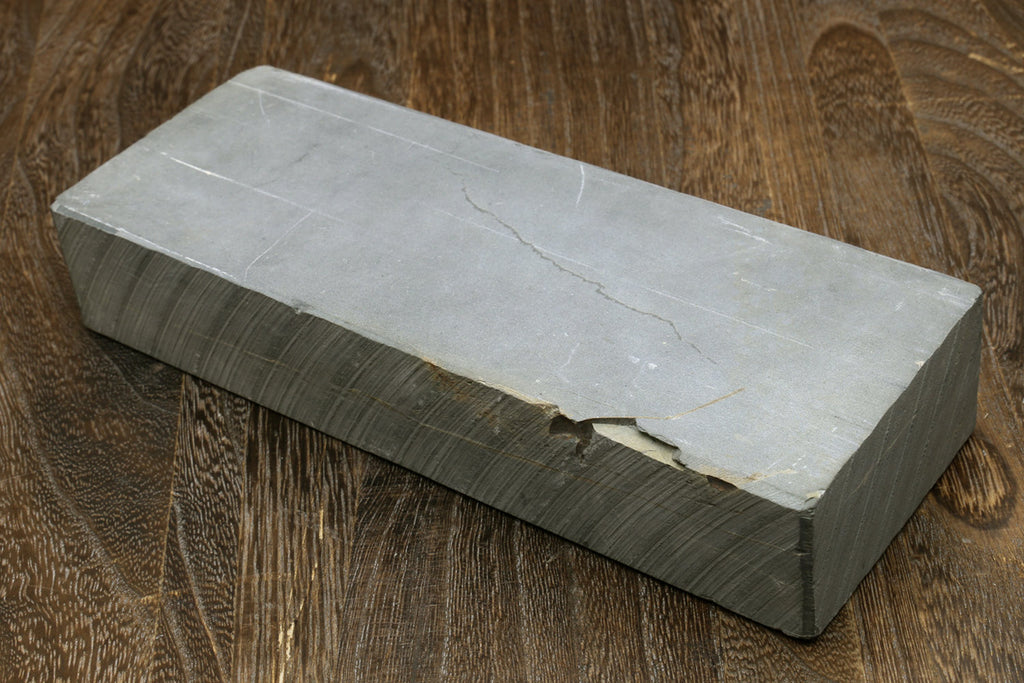 Natural sharpening whetstone block, light top face over dark gray body