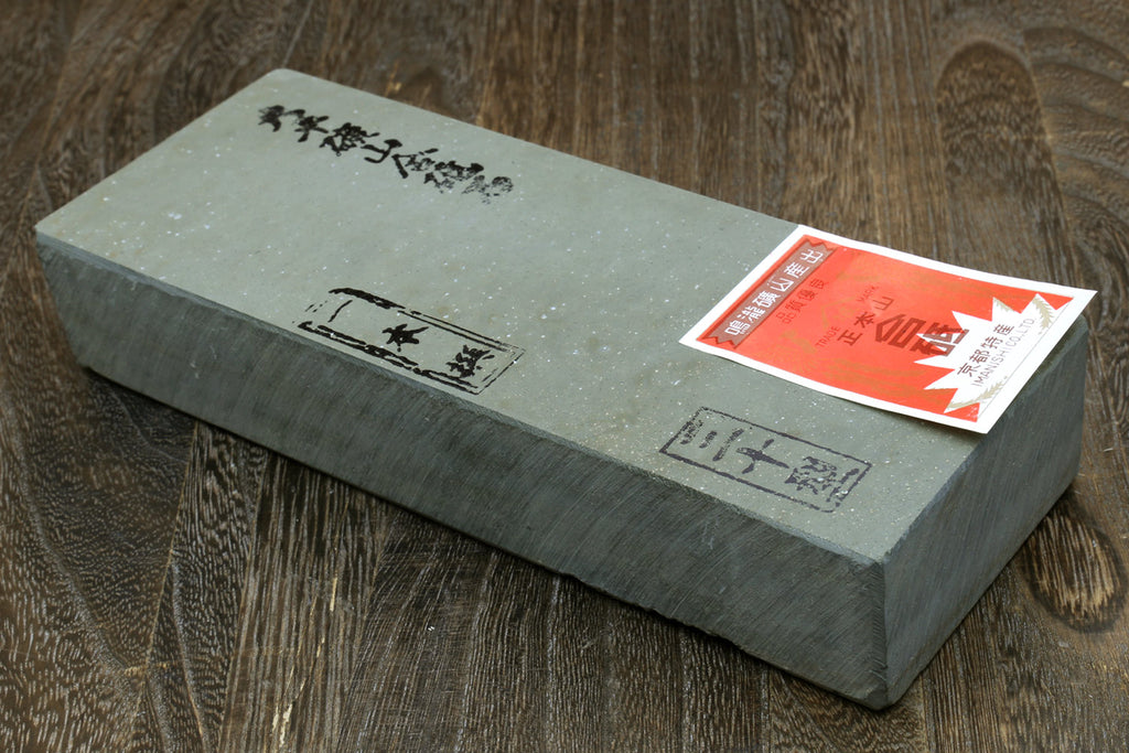 Natural sharpening whetstone, rectangular gray stone with stamped markings and label