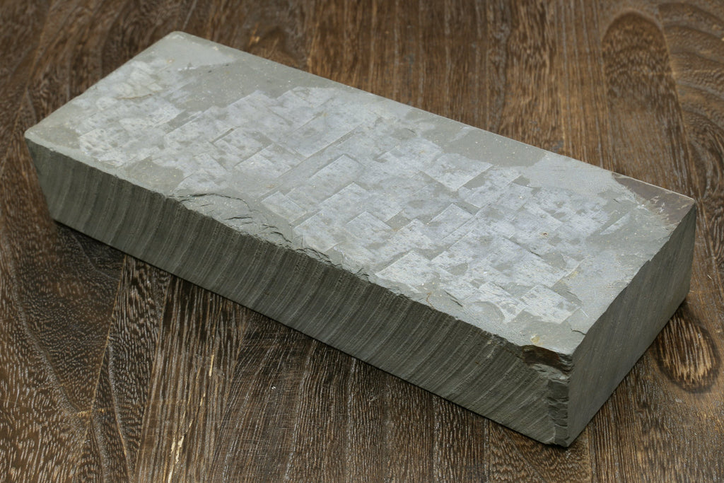 Rectangular sharpening whetstone with pale textured top surface