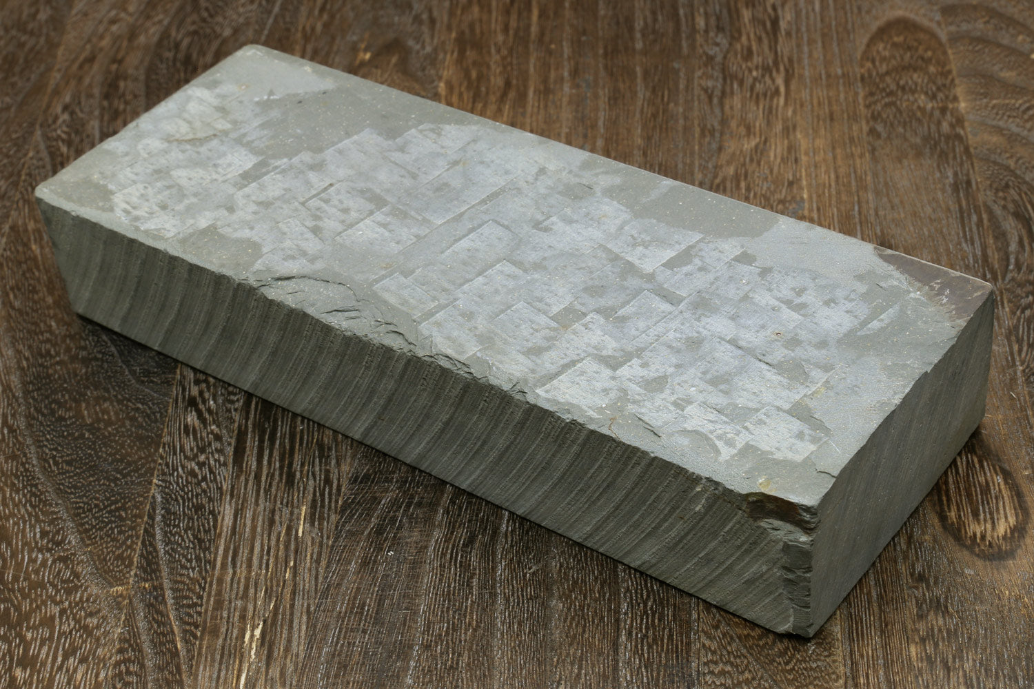 Rectangular sharpening whetstone with pale textured top surface