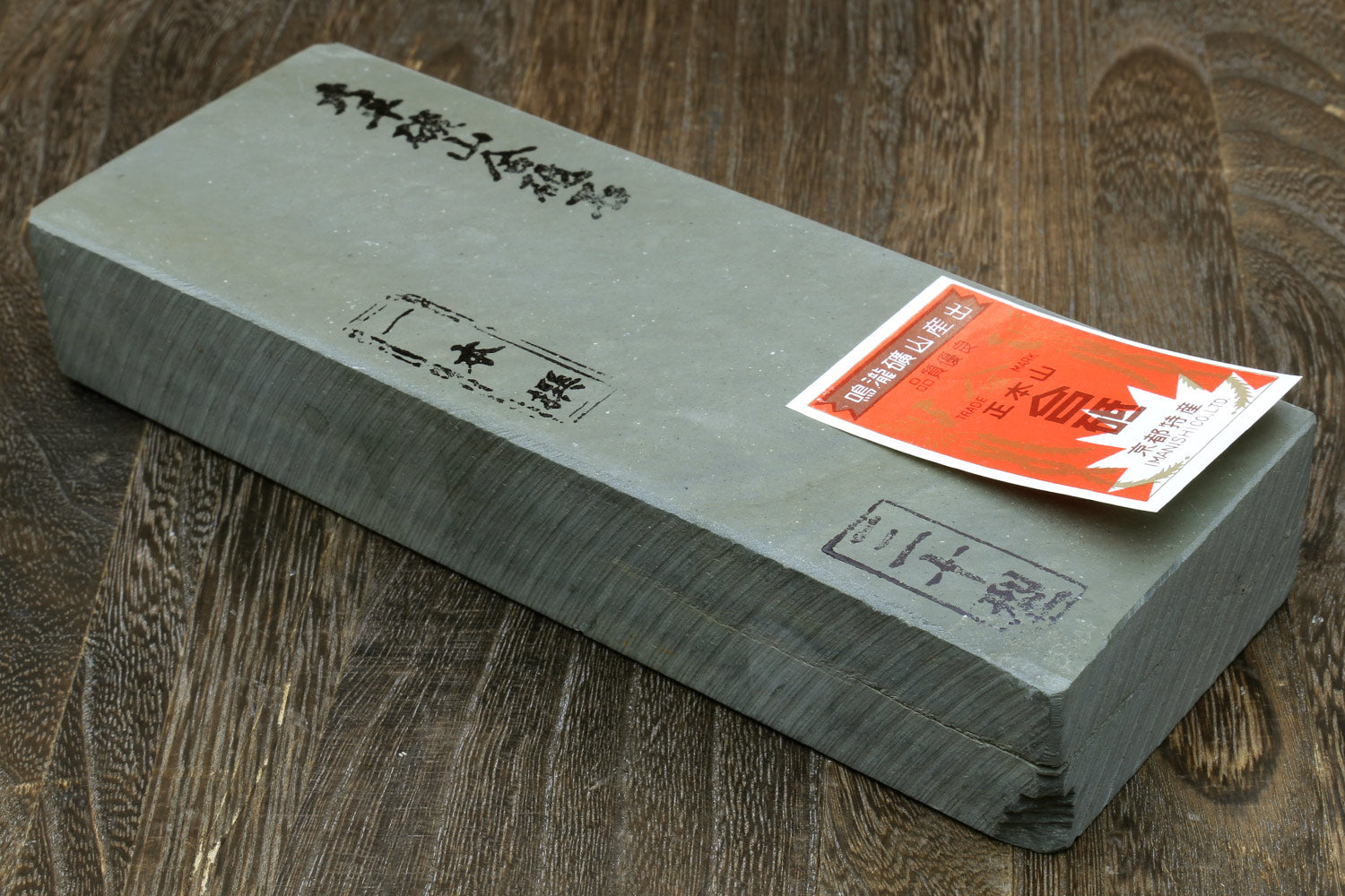 Rectangular natural whetstone block, gray-green, with red label