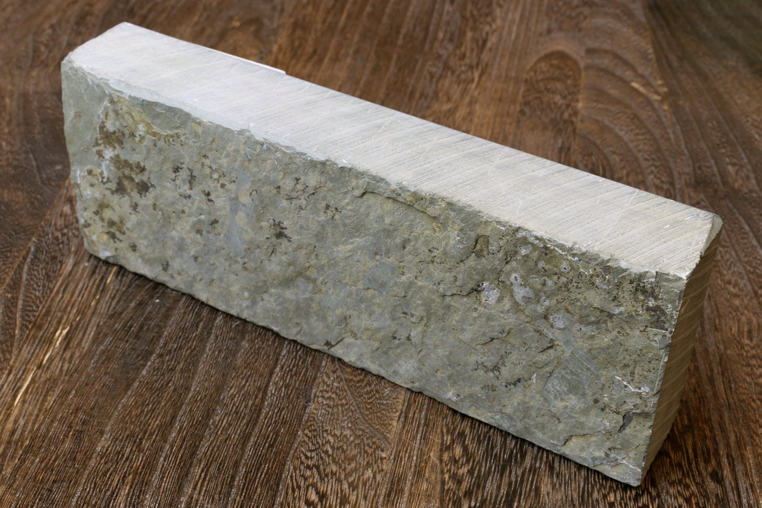 Natural sharpening whetstone block, pale green mottled face with light gray sides