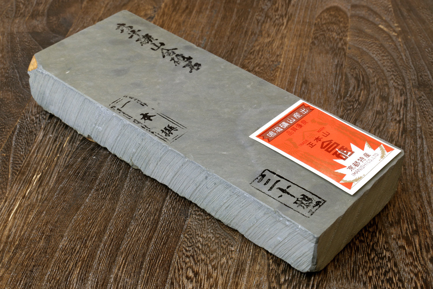 Sharpening whetstone, light gray rectangular block with printed markings and red label