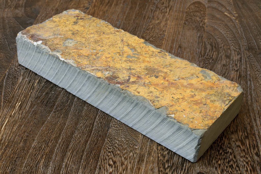 Sharpening whetstone, yellow mottled rectangular block with ridged pale edges