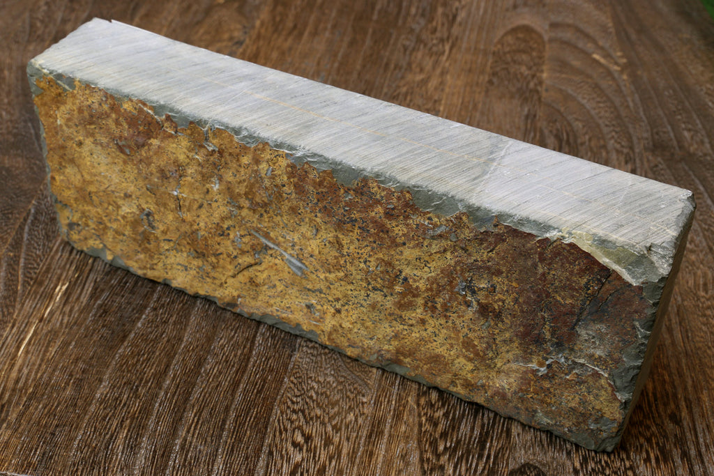 Natural sharpening whetstone, rectangular with mottled yellow-brown and gray sides
