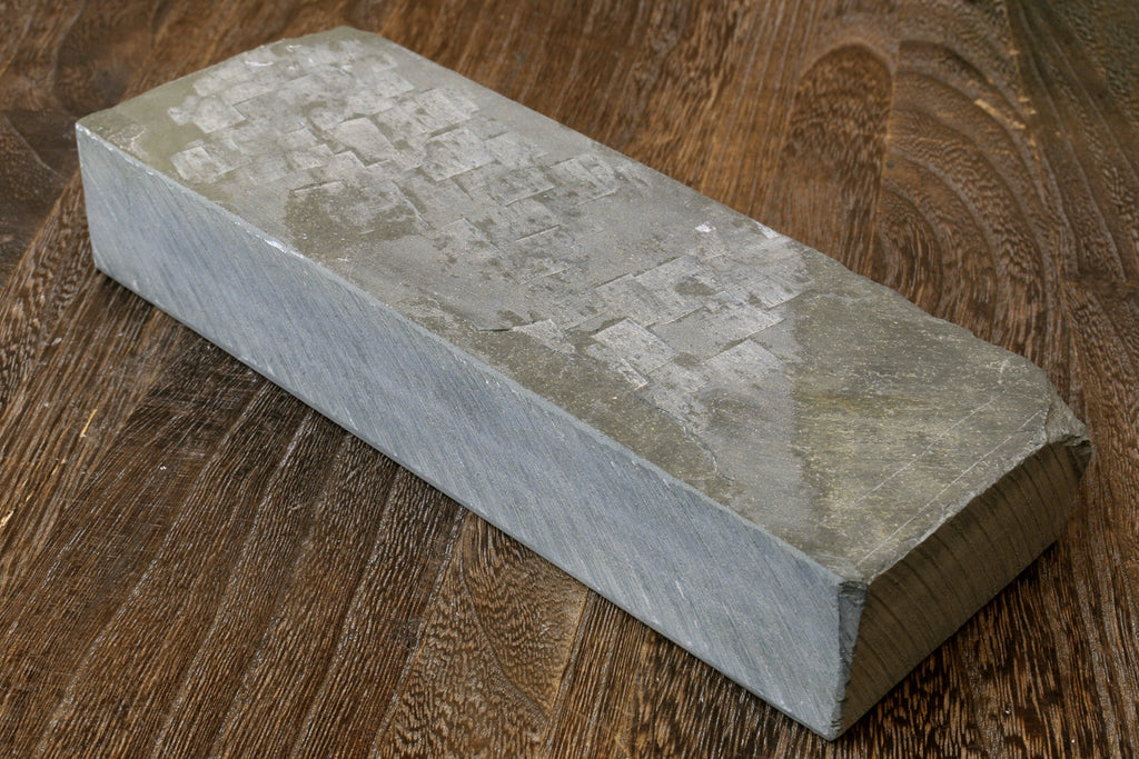 Rectangular natural sharpening whetstone, pale gray, top surface with markings