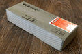 Natural sharpening whetstone with end labels, rectangular stone block