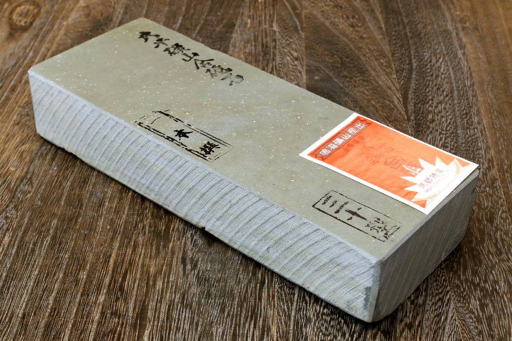 Natural sharpening whetstone finishing stone, light beige with orange label and markings