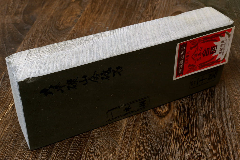 Natural whetstone finishing stone, long rectangular black base with red end label
