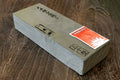 Natural sharpening whetstone, rectangular light-gray stone block with flat faces