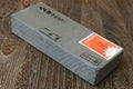 Yoshihiro whetstone finishing stone box, pale gray block with red label and logo