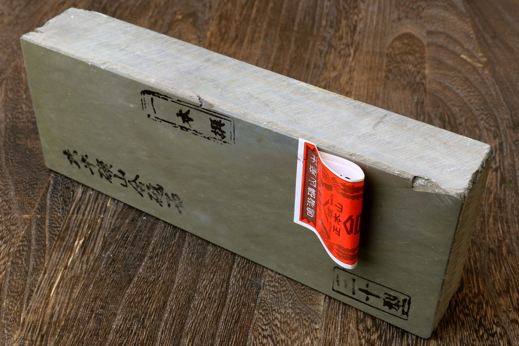 Natural sharpening whetstone block with Japanese markings and orange product label on side