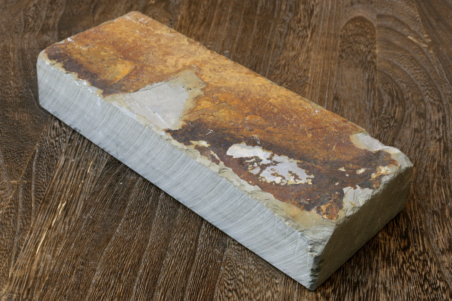 Whetstone sharpening stone, pale base with brown and white wear marks on rectangular block