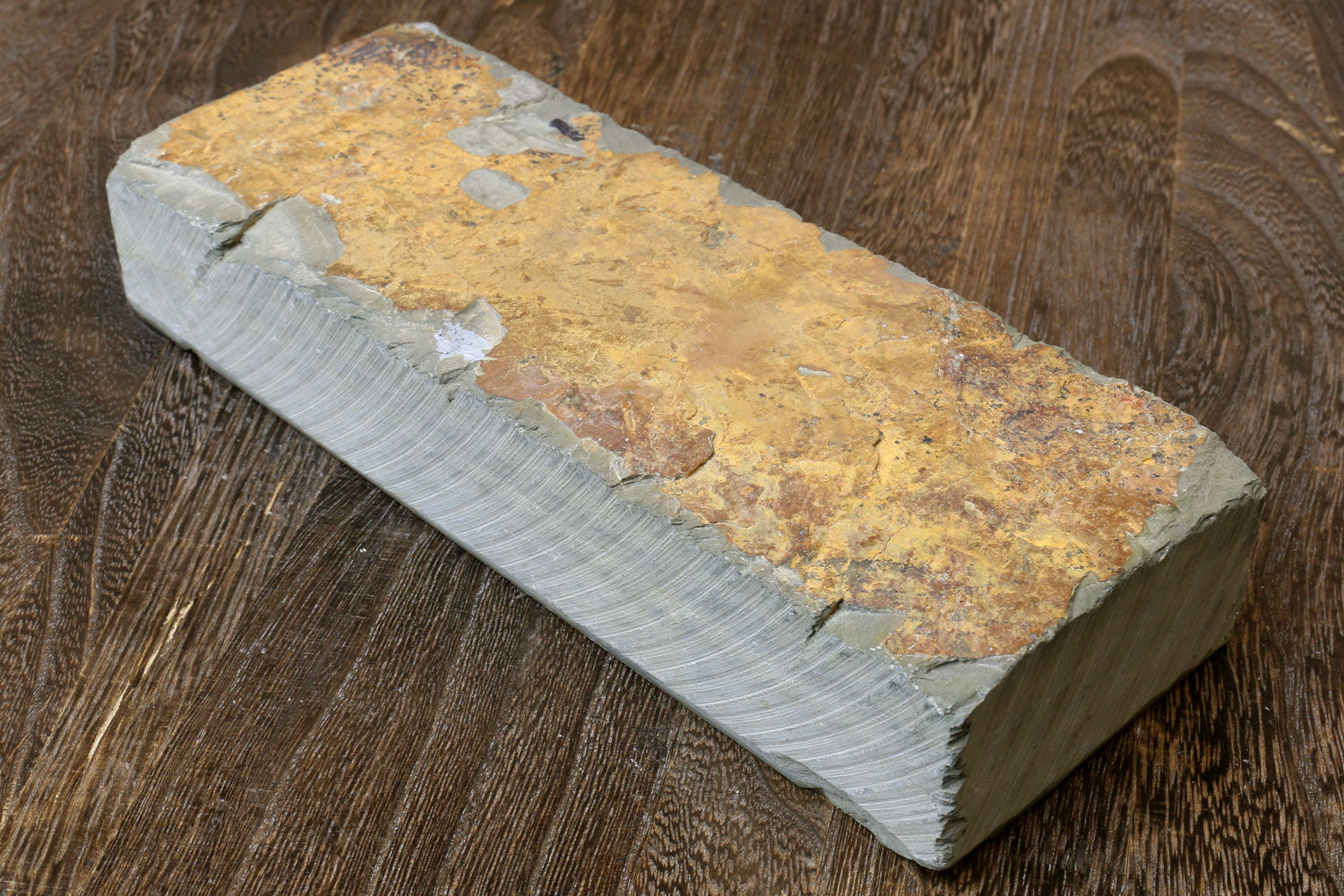 Natural whetstone block, yellow-brown stone with white side and rough edges.
