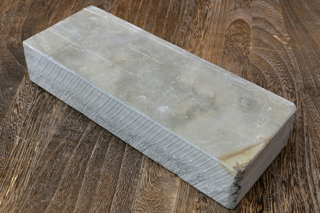 Natural sharpening whetstone, pale gray rectangular stone block with straight edges