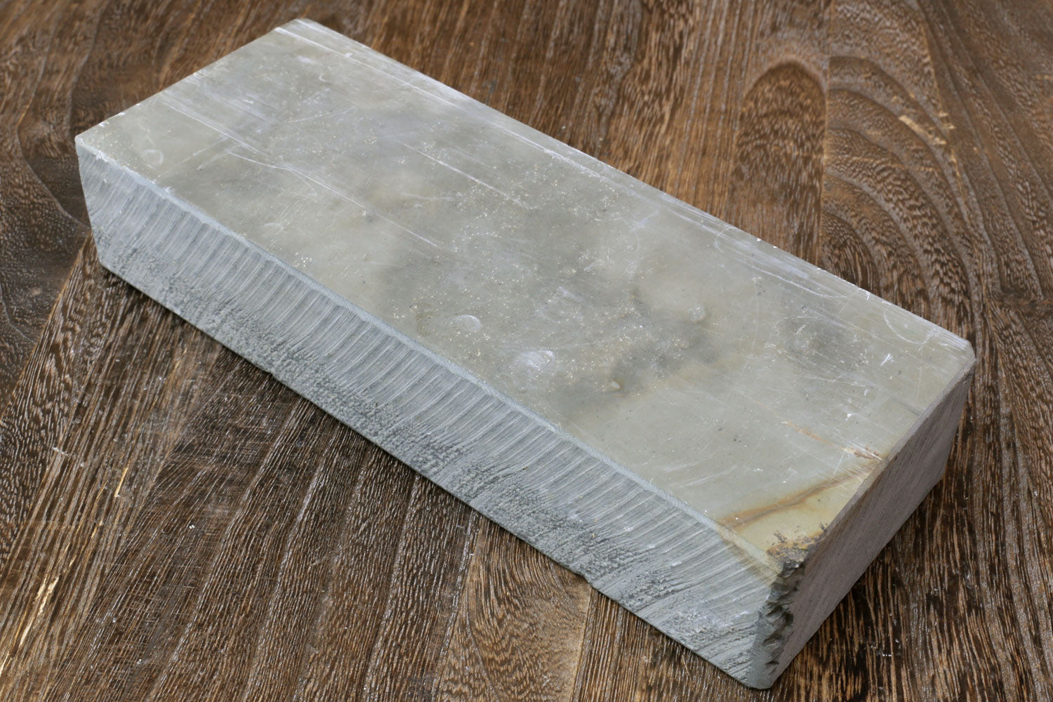 Natural sharpening whetstone, pale gray rectangular stone block with straight edges