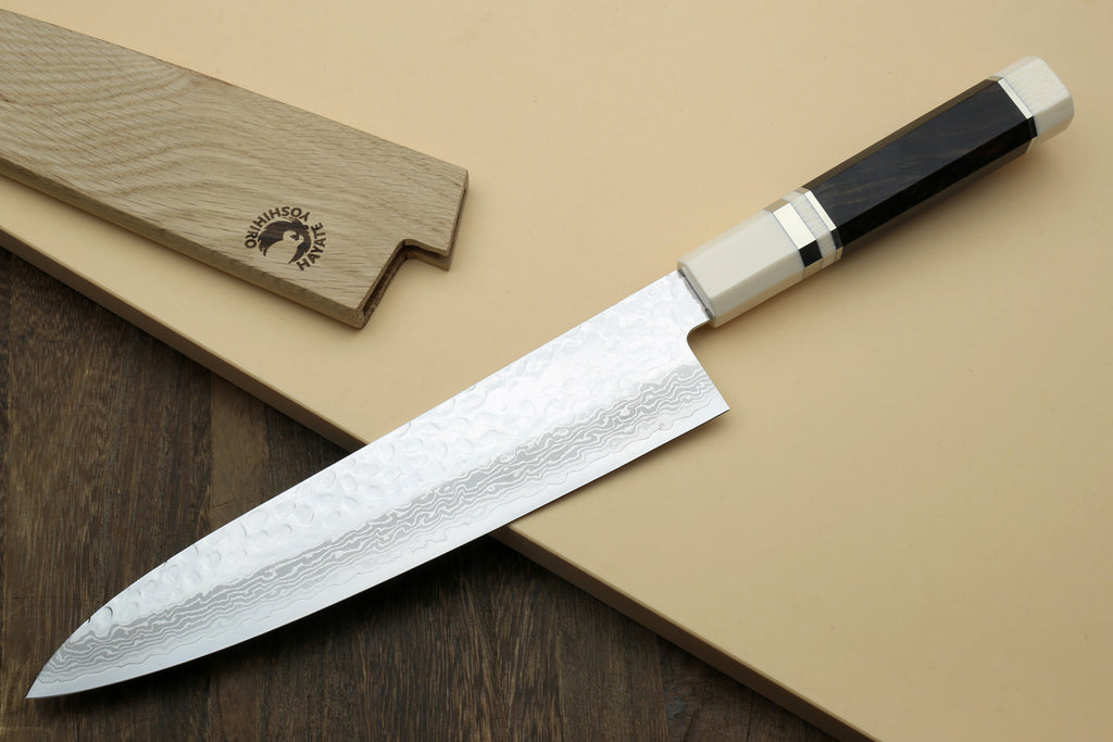 Japanese chef’s gyuto knife with hammered Damascus blade and white handle