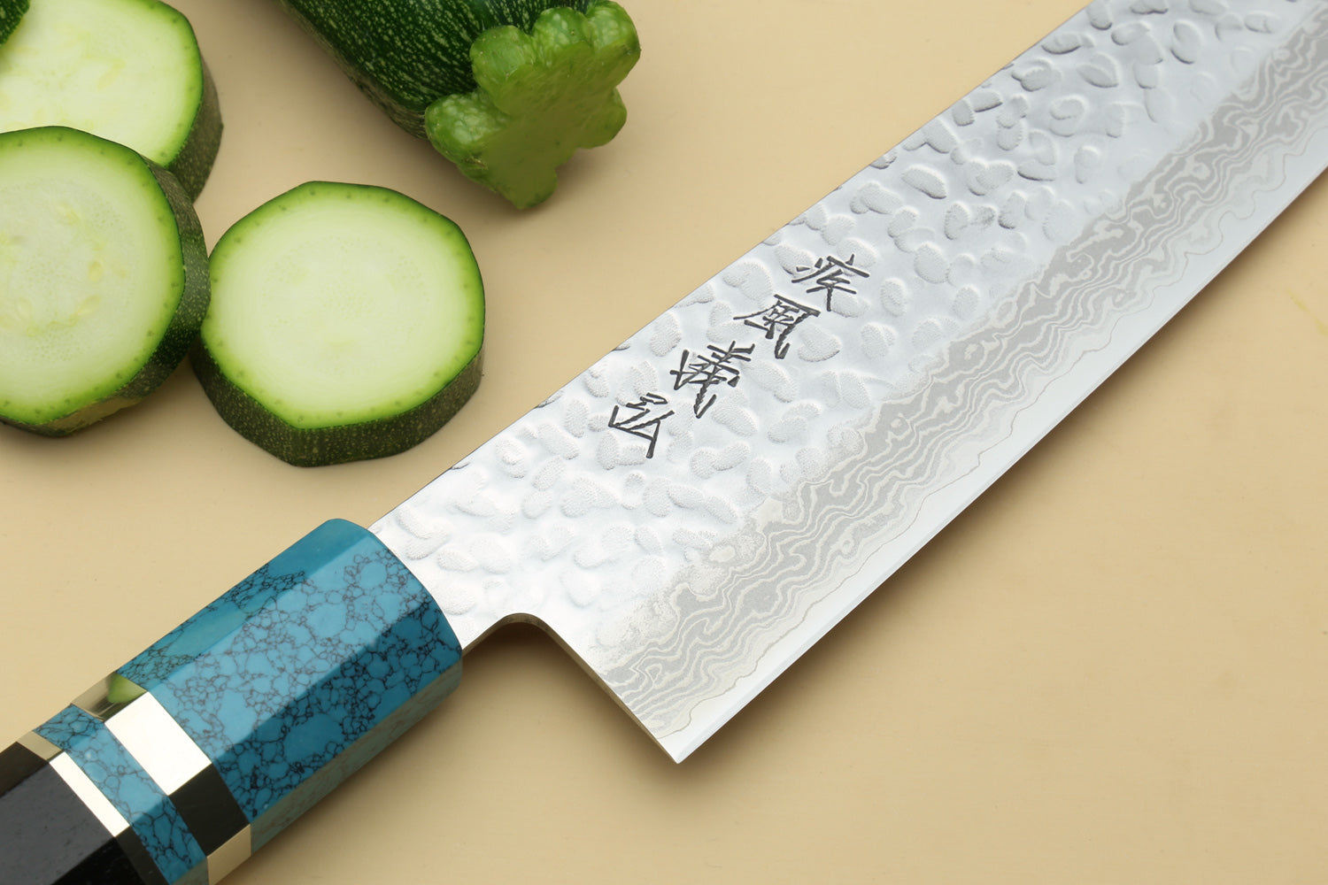 Chef's gyuto knife with hammered Damascus blade, stamped characters, and turquoise octagonal handle