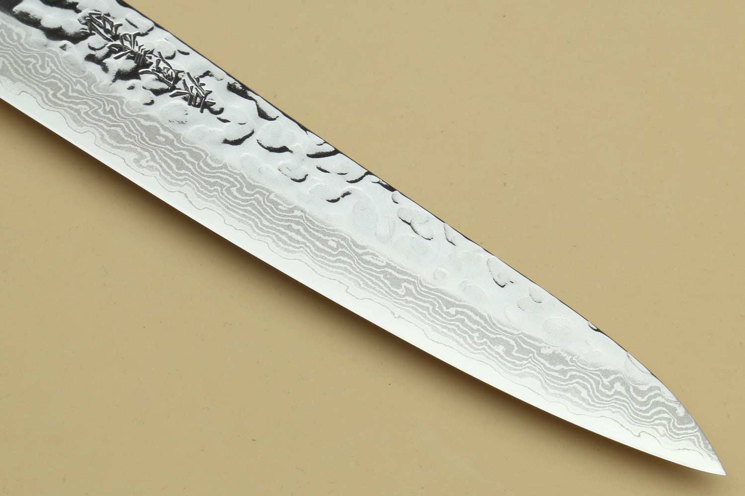 Damascus steel knife blade close-up with wave-pattern steel texture