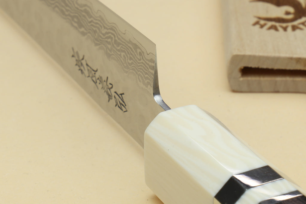 Damascus blade with Japanese characters and ivory handle with black collar