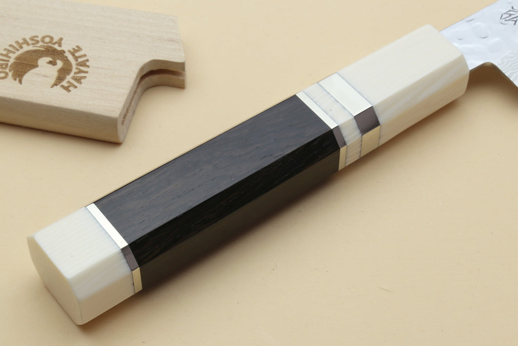 Damascus petty knife handle end with ivory scales and dark center spine