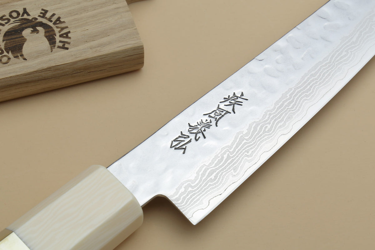 Yoshihiro VG-10 petty knife blade close-up with etched characters, Damascus wavy pattern