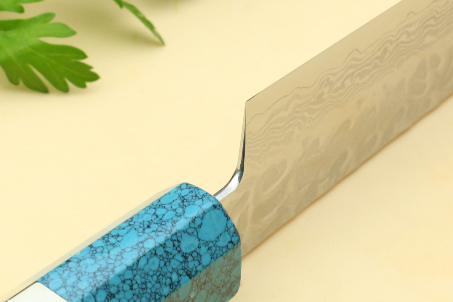 Petty knife blade edge and turquoise blue handle with textured pattern.