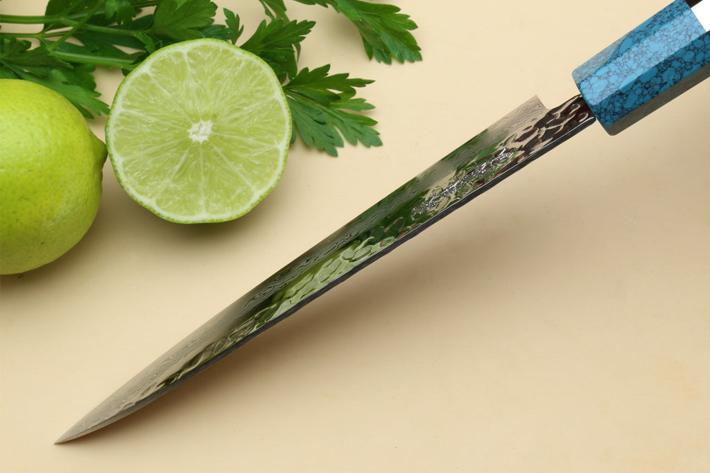 Petty utility chef knife with Damascus blade and turquoise blue octagonal handle.