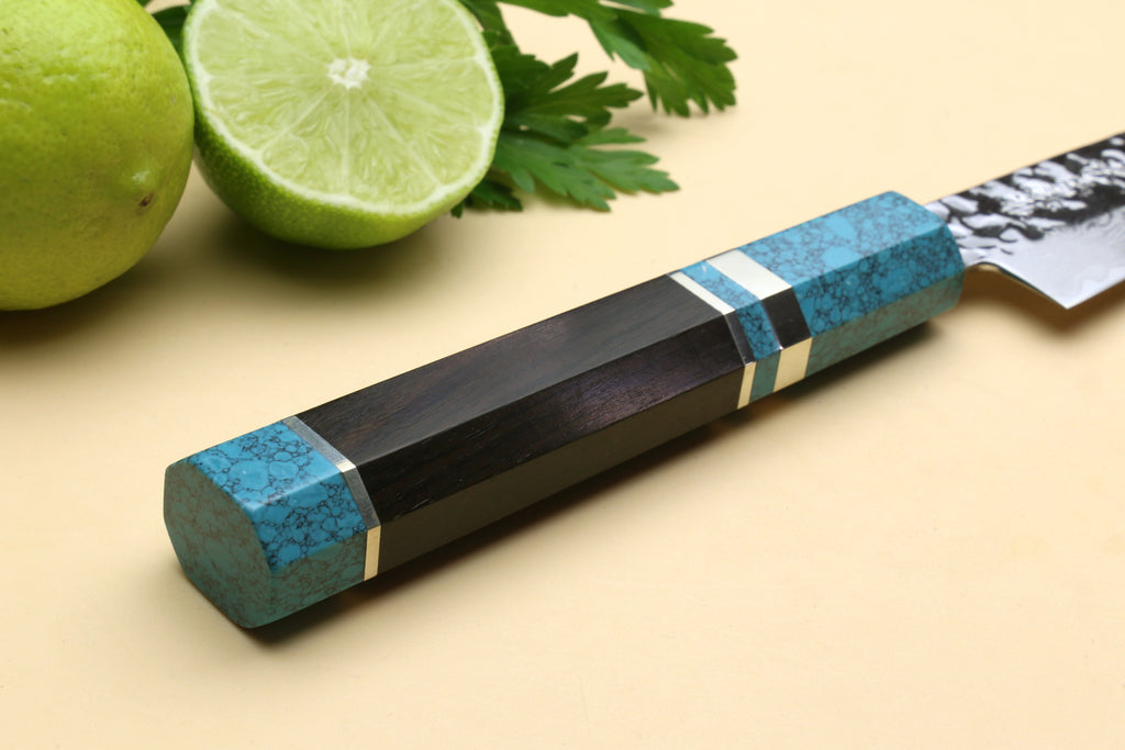 Octagonal turquoise blue handle with black cap accents on a Damascus blade.
