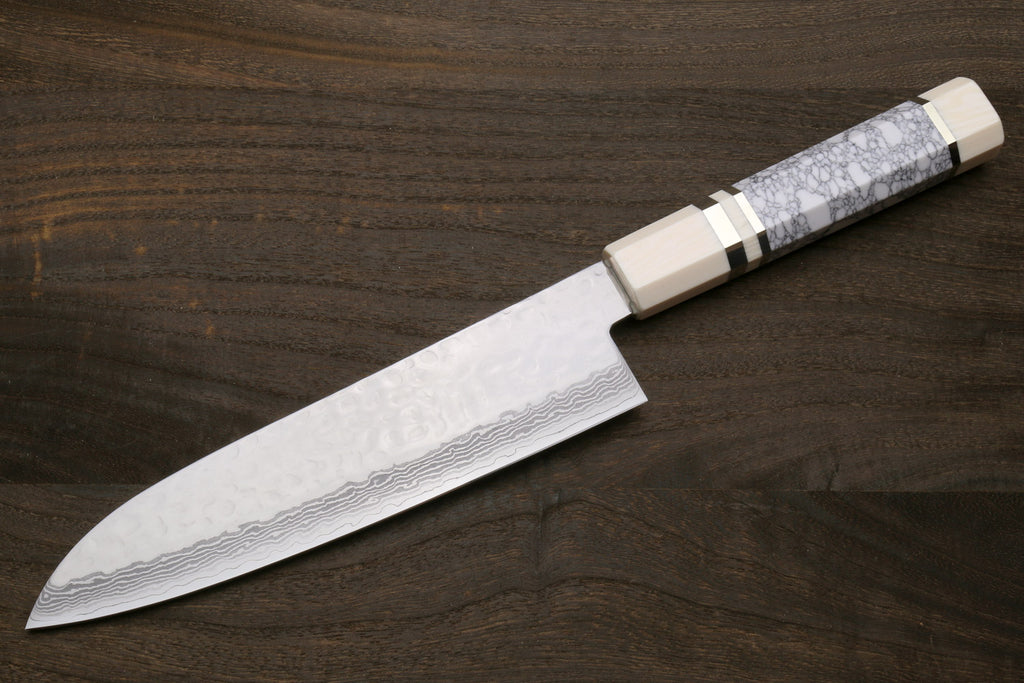 Damascus santoku knife side view with white howlite scales and ivory-toned bolster