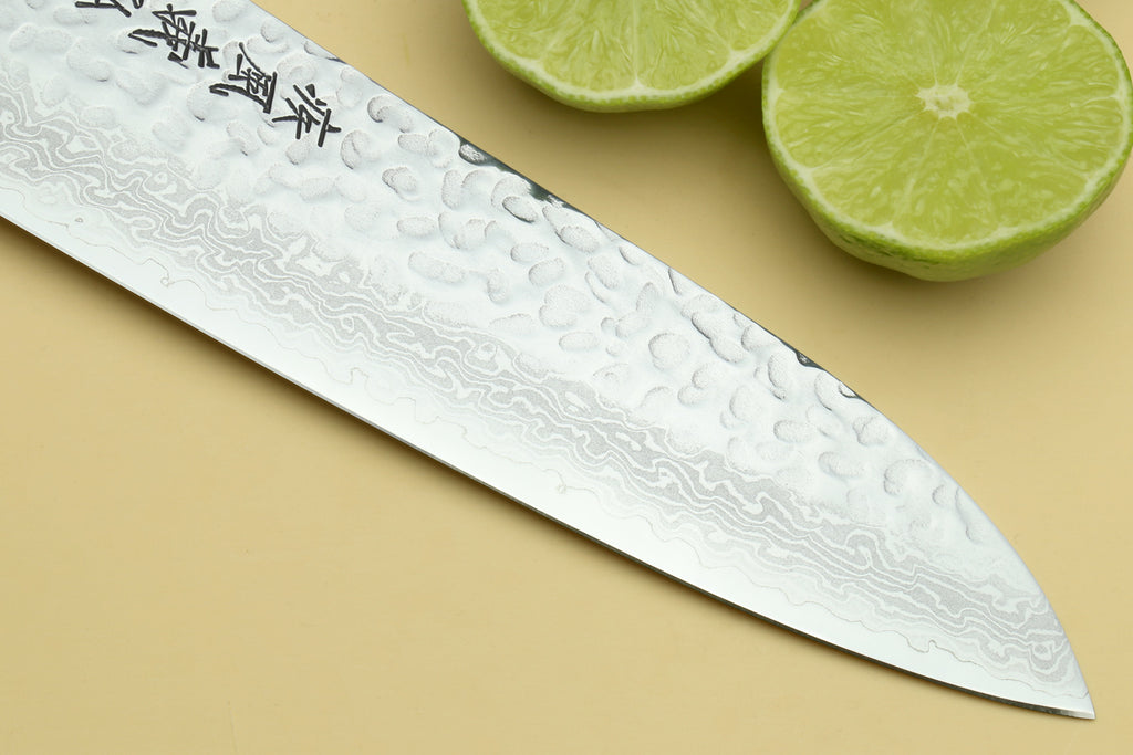 Santoku knife blade with hammered Damascus pattern and etched characters