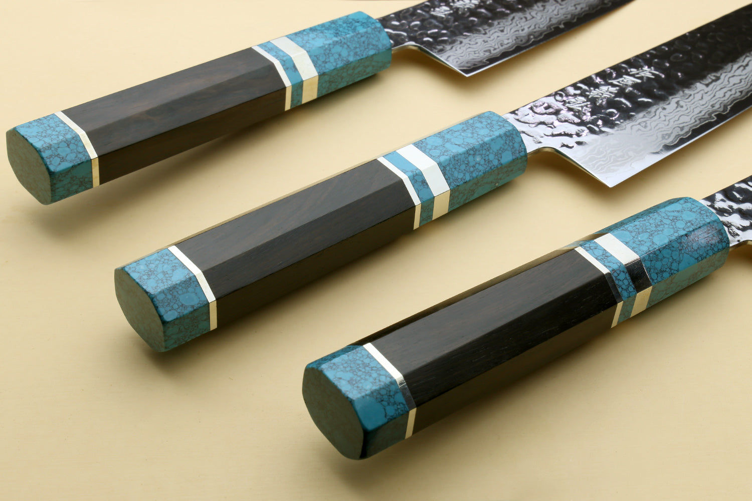 Santoku knives with turquoise blue octagonal handles and hammered Damascus blades