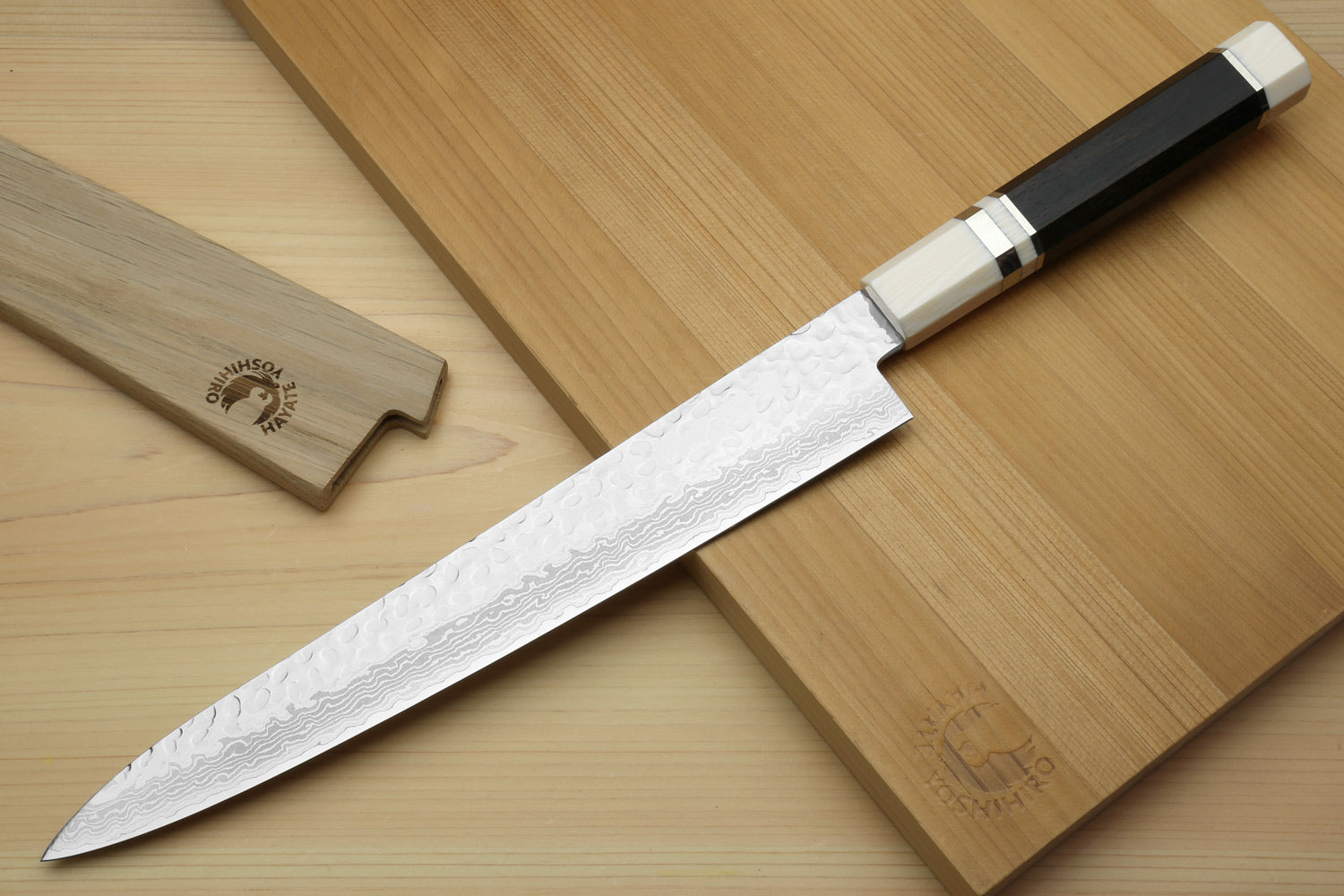Japanese sujihiki slicer knife with damascus blade and black-and-ivory handle