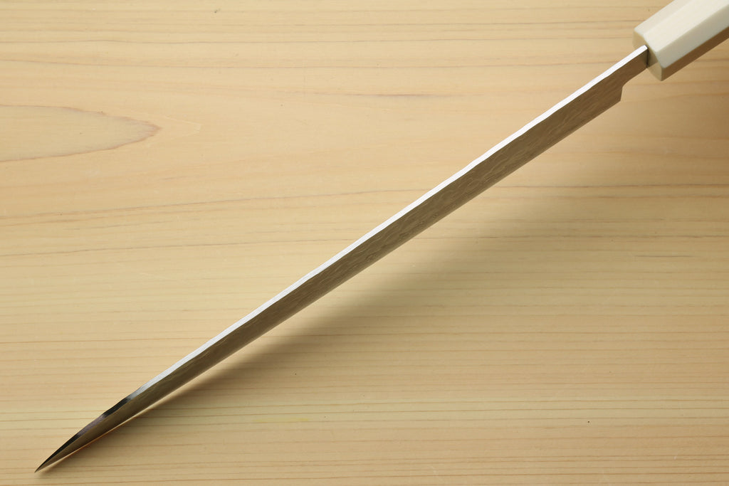 Japanese sujihiki slicer knife tip and spine with damascus blade and ivory-toned handle