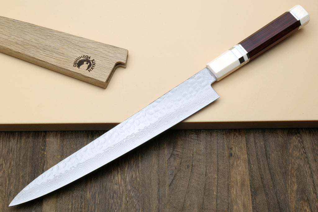 Damascus sujihiki slicer knife showing curved tip and hammered blade texture