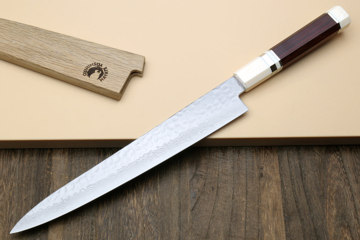 Damascus sujihiki slicer knife showing curved tip and hammered blade texture