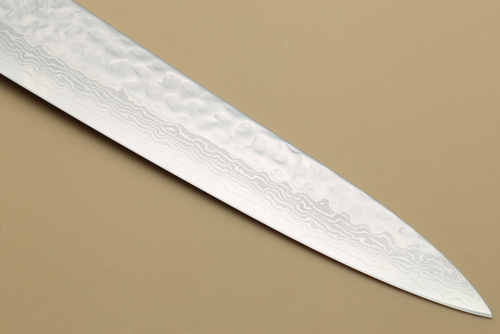 Damascus hammered blade close-up with light etching pattern