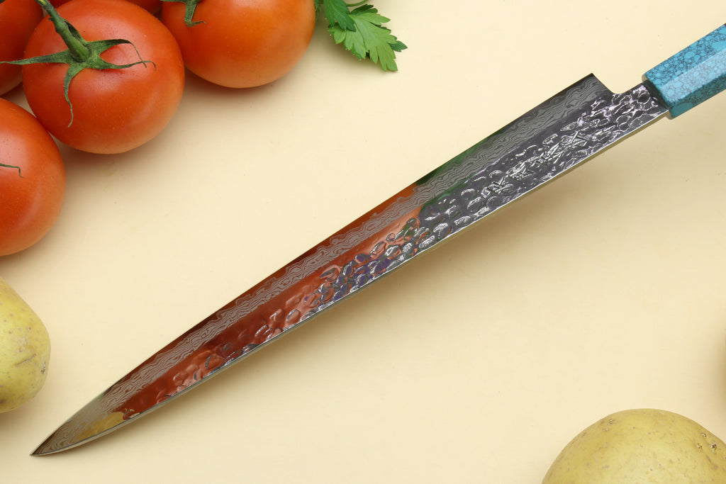 Damascus sujihiki knife with turquoise handle and reddish-brown damascus blade