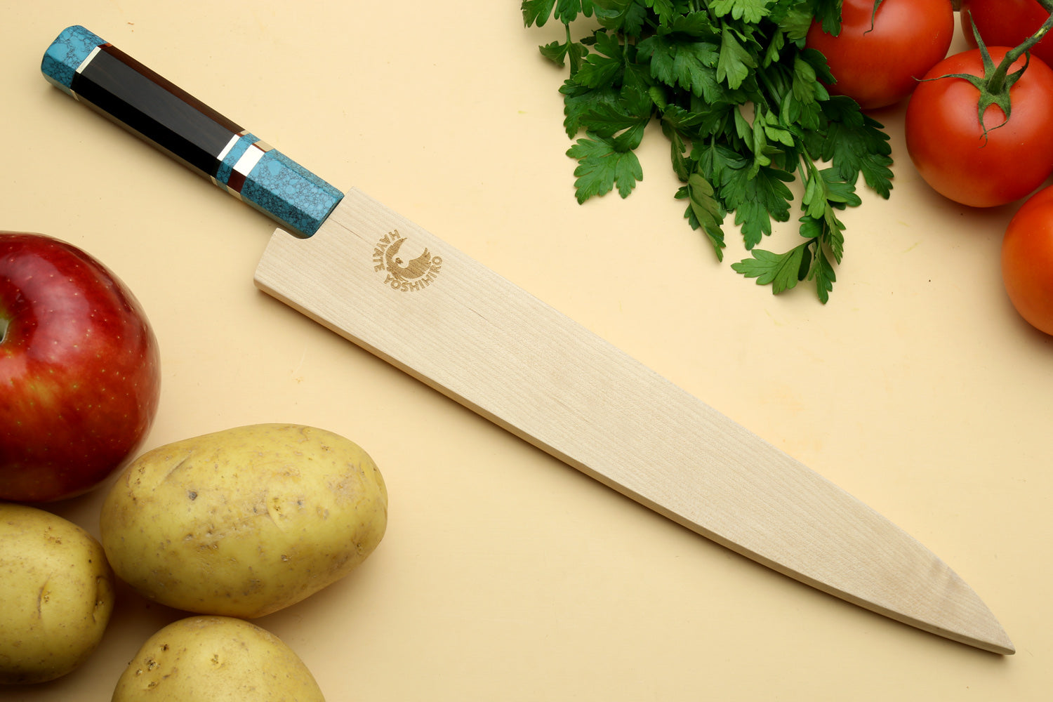 Damascus sujihiki knife with turquoise octagonal handle and long angled silver blade