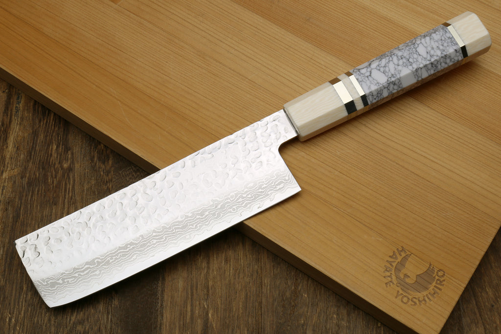 Nakiri vegetable knife with white howlite handle and Damascus blade on wooden board