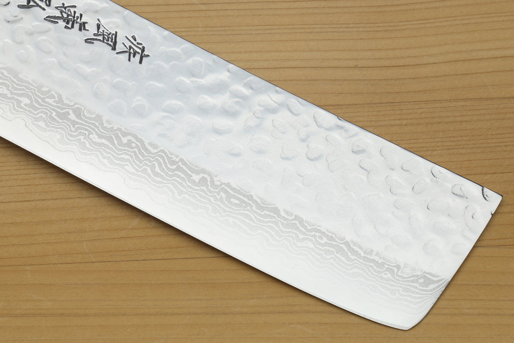 White howlite-handled nakiri knife, hammered Damascus blade edge close-up